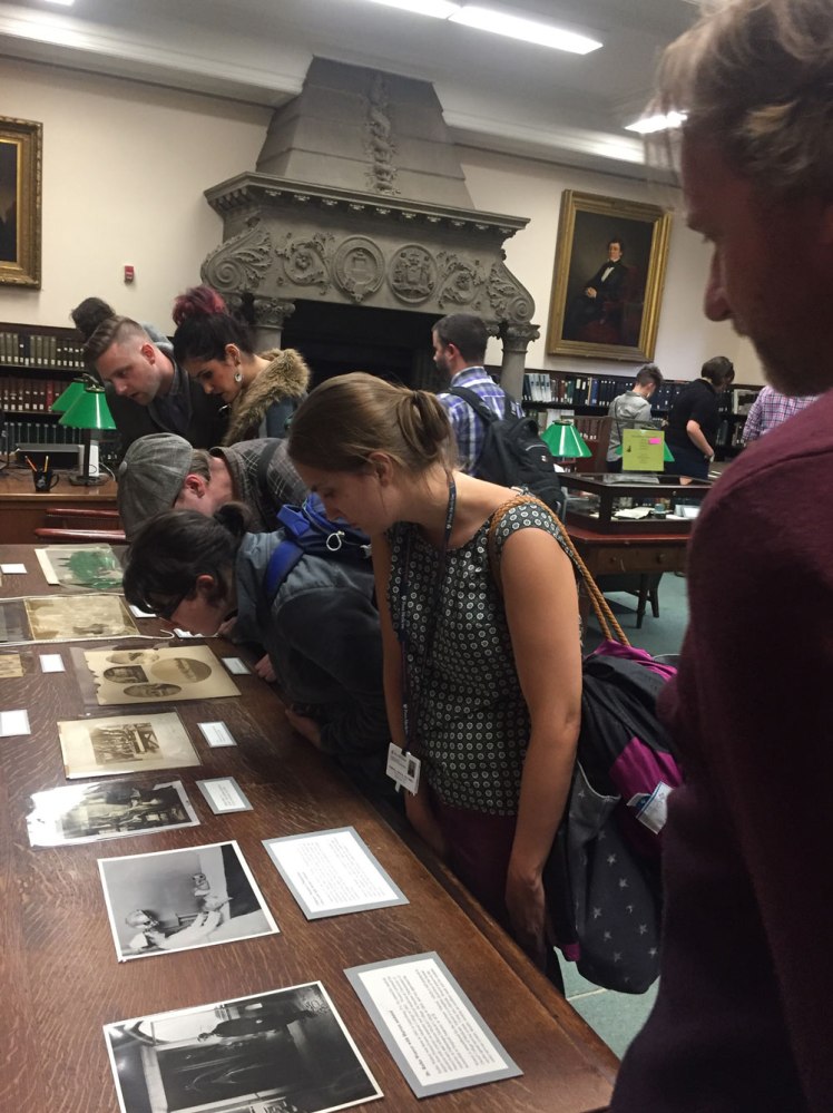 visitors looking at photographs on display