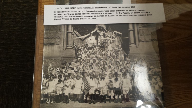 black and white photograph of a group of german american children holding american flags