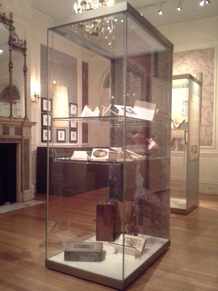 a display case full of books open to their bookplates