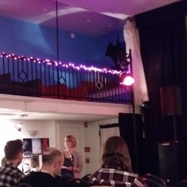 Speaker in front of small group of viewers.