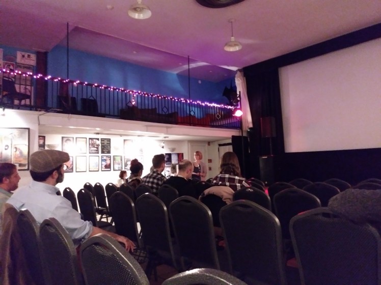 Speaker in front of small group of viewers.