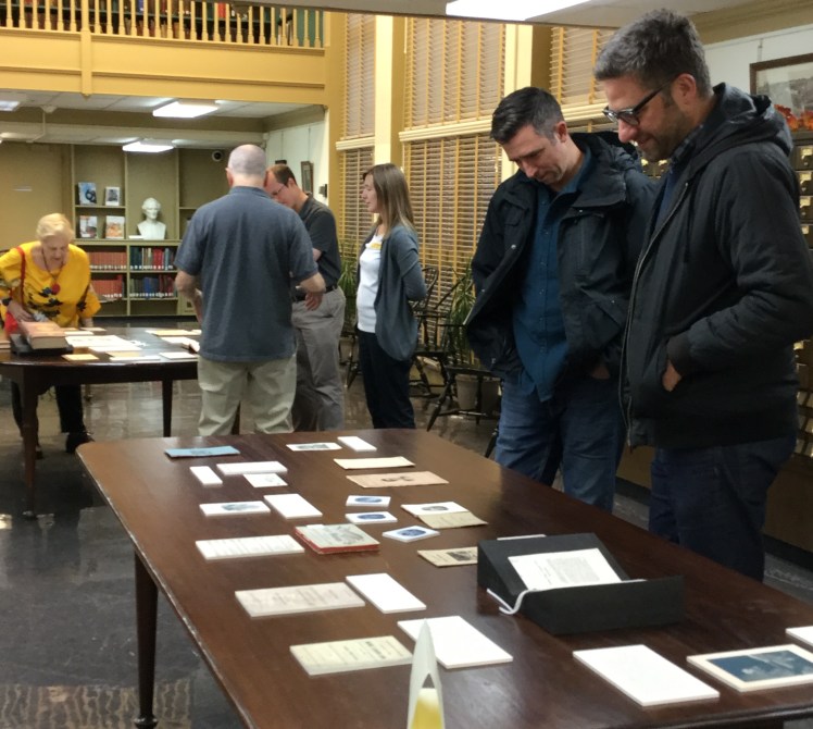 Event attendees viewing materials laid out on tables in the PHS reading room.