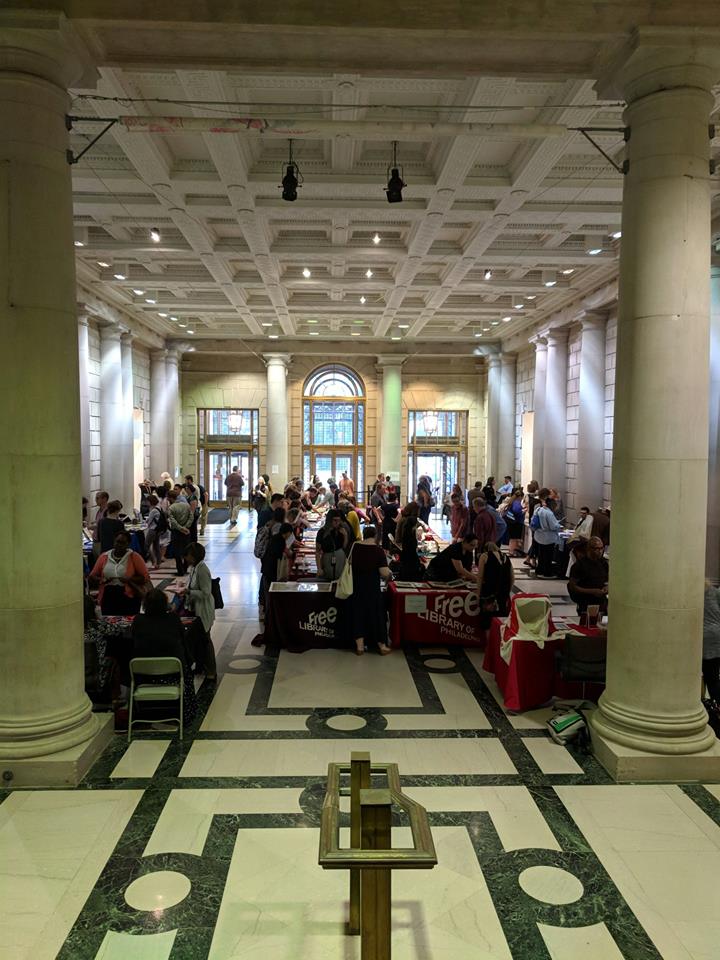 Attendees gathered and mingling in the atrium of the Free Library of Philadelphia.
